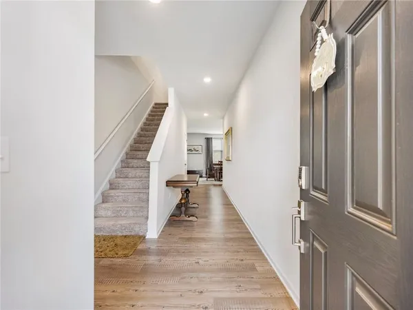 a view of a hallway with wooden floor and entryway