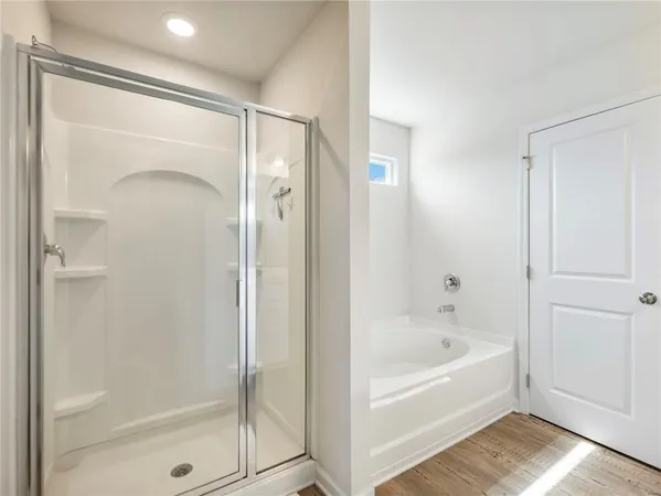 a view of walk in closet with clothes