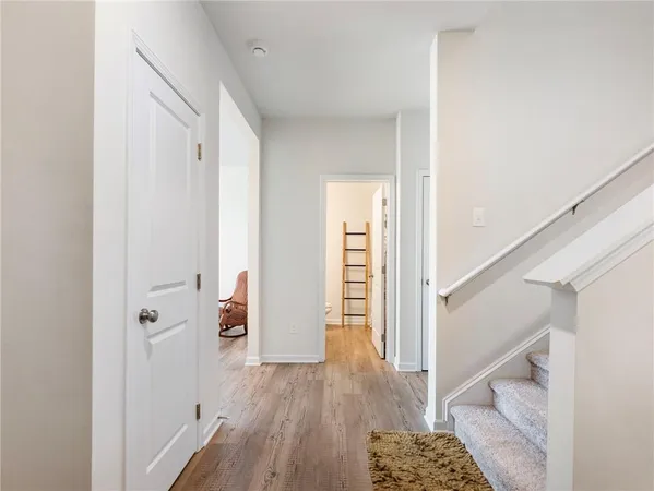 a view of a hallway with wooden floor and entryway