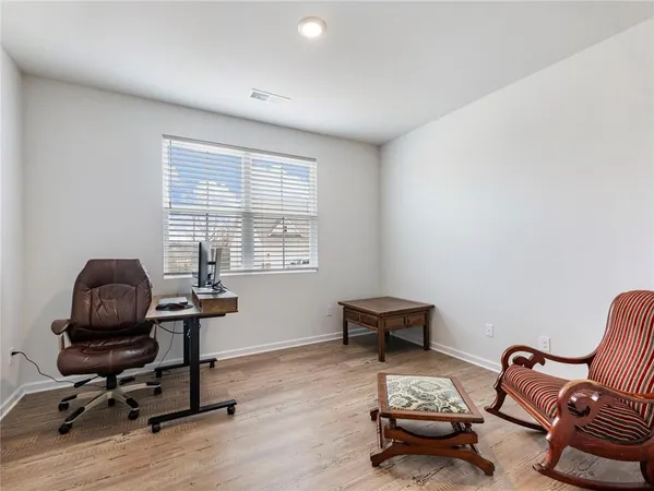 a livingroom with workspace and a window
