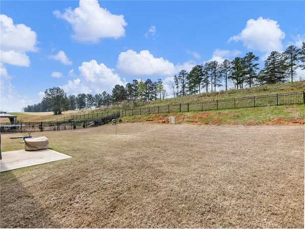 a view of a house with a yard and sitting area