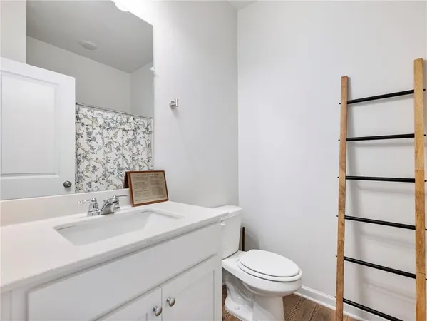 a bathroom with a sink toilet and a mirror