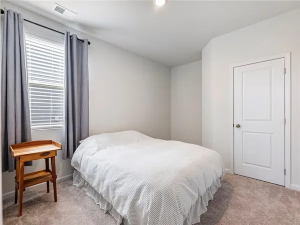 a bedroom with a bed and a chair