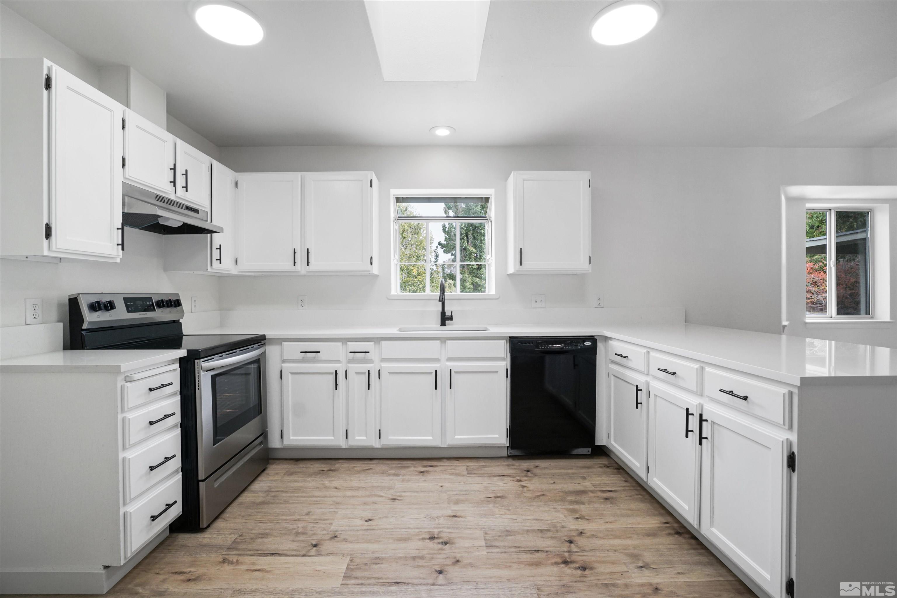 4046 Cimarron Road Fallon, NV 89406 - Photo 8 of 30 a kitchen with granite countertop white cabinets white stainless steel appliances with a sink and dishwasher