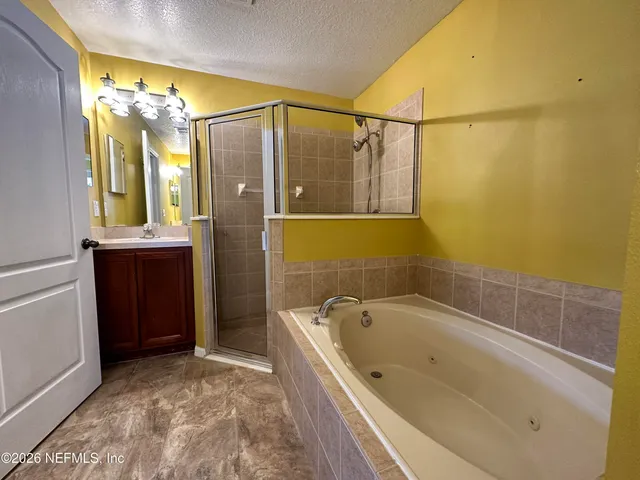 a bathroom with a bathtub and shower
