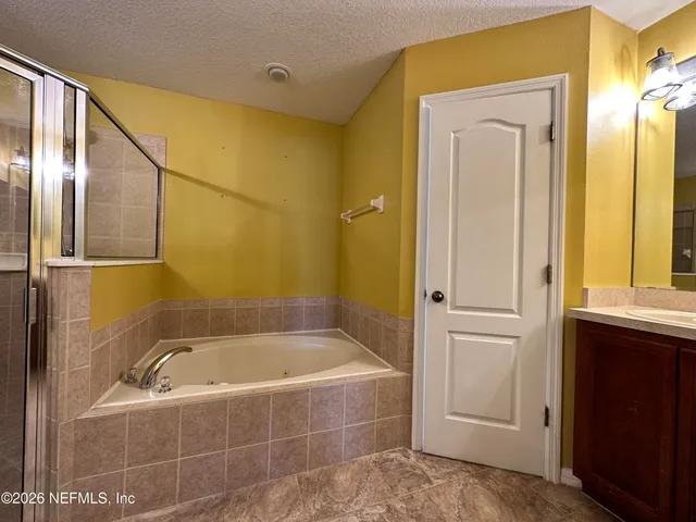 a bathroom with a bathtub and shower
