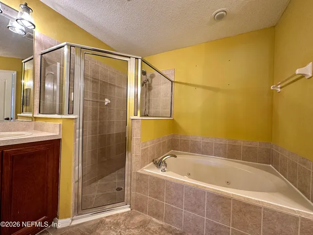 a bathroom with a bathtub and shower