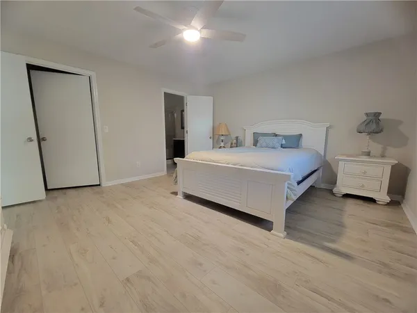 a spacious bedroom with a bed and a cabinets