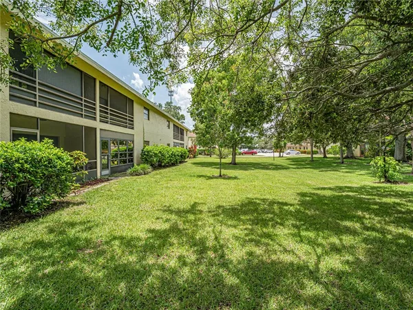 a view of a house with a backyard