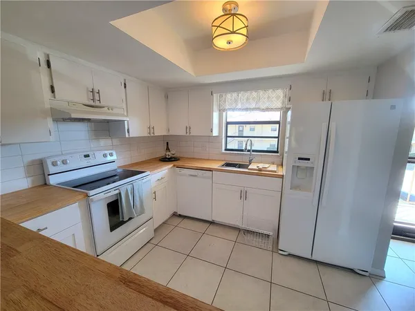 a kitchen with a stove a sink and a refrigerator