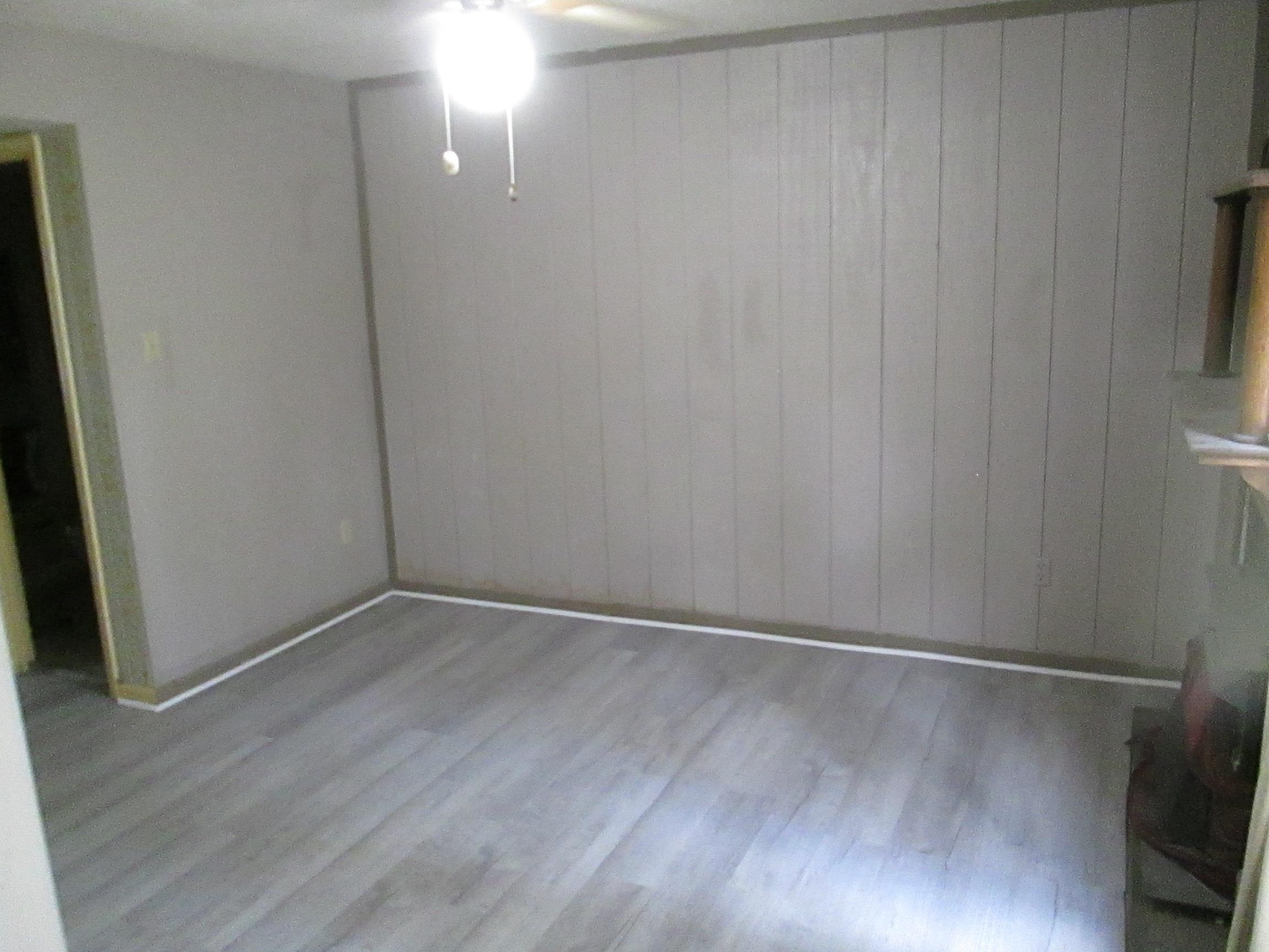 5252 Johns River Road, Unit 5252 Memphis, TN 38116 - Photo 11 of 12 a view of an empty room with wooden floor and a window