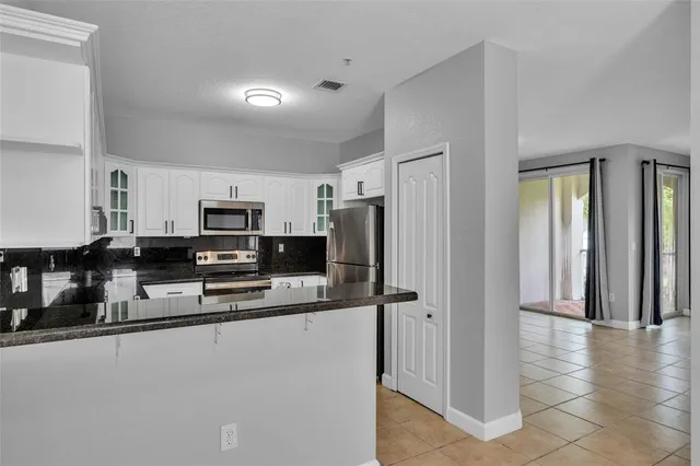 a kitchen with stainless steel appliances a refrigerator and a stove top oven