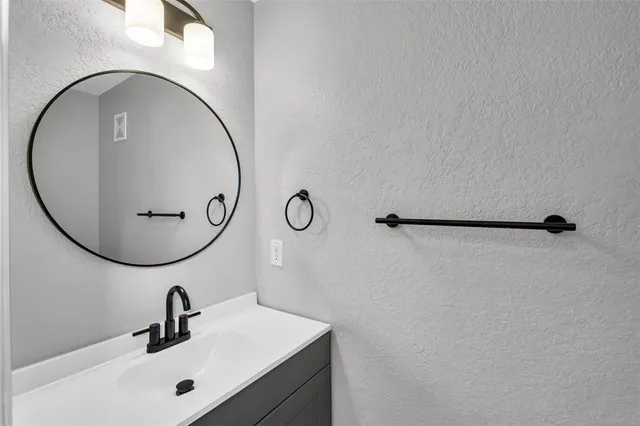a bathroom with a sink and mirror