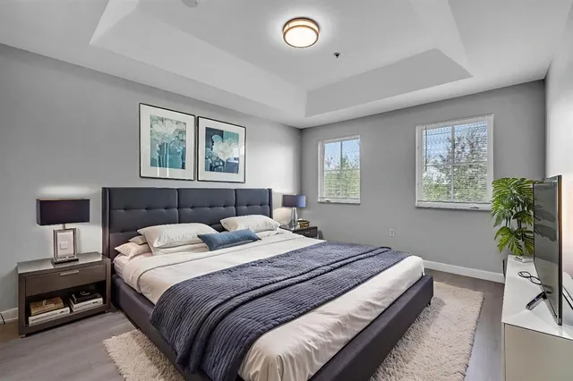 a bedroom with bed and a potted plant