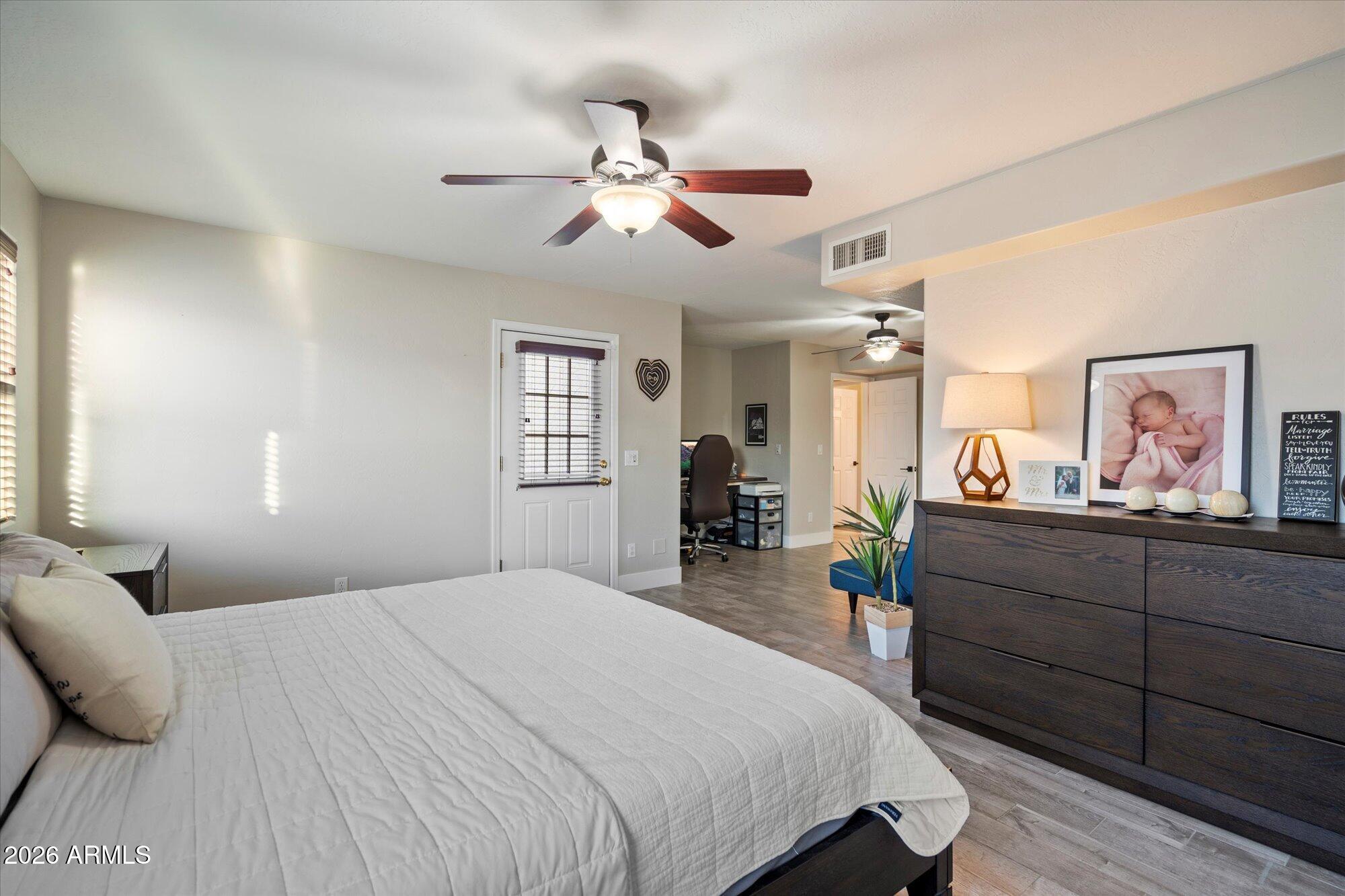 10245 North 34th Place Phoenix, AZ 85028 - Photo 12 of 27 a bed room with a bed and a chandelier