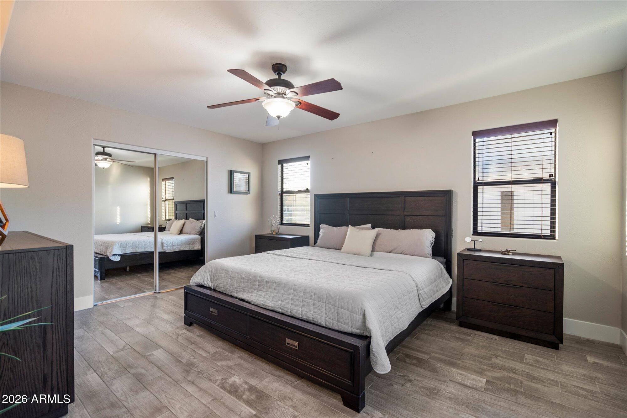 10245 North 34th Place Phoenix, AZ 85028 - Photo 13 of 27 a spacious bedroom with a bed and a chandelier