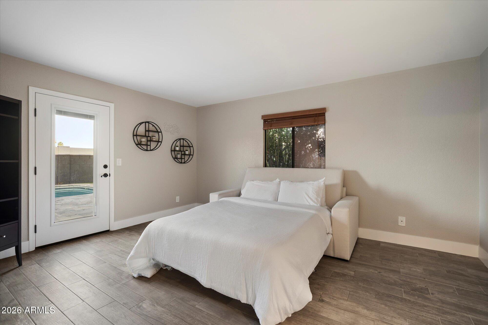 10245 North 34th Place Phoenix, AZ 85028 - Photo 15 of 27 a bedroom with a bed and a large mirror