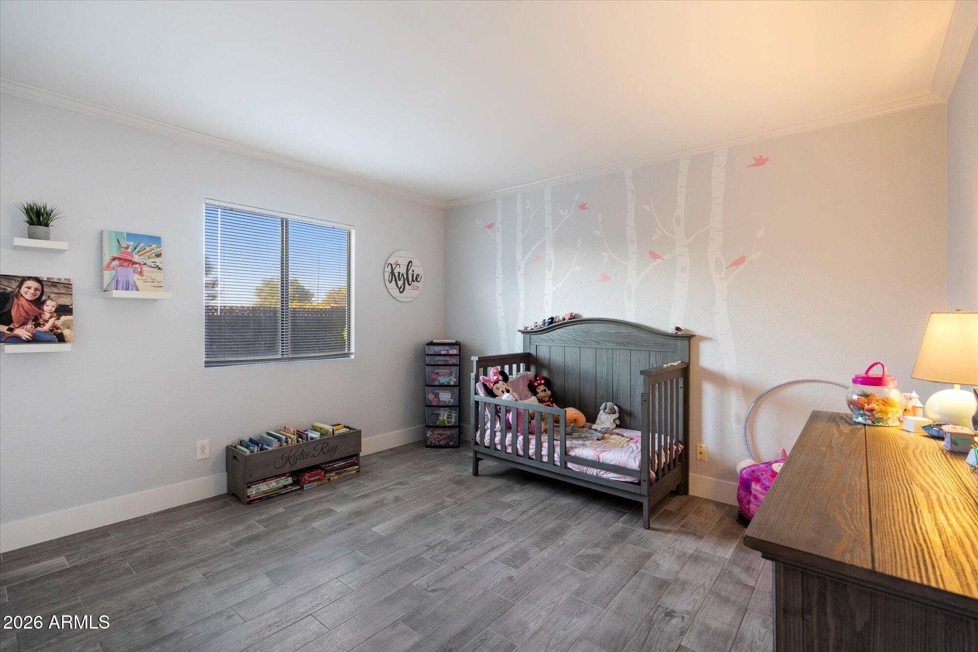 10245 North 34th Place Phoenix, AZ 85028 - Photo 17 of 27 a bedroom with furniture and a wooden floor
