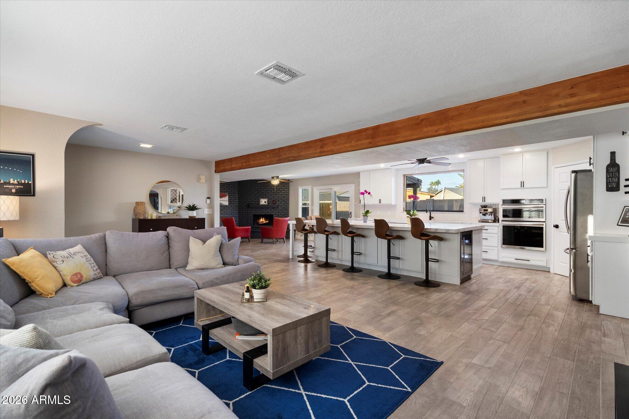 10245 North 34th Place Phoenix, AZ 85028 - Photo 3 of 27 a living room with furniture and kitchen view