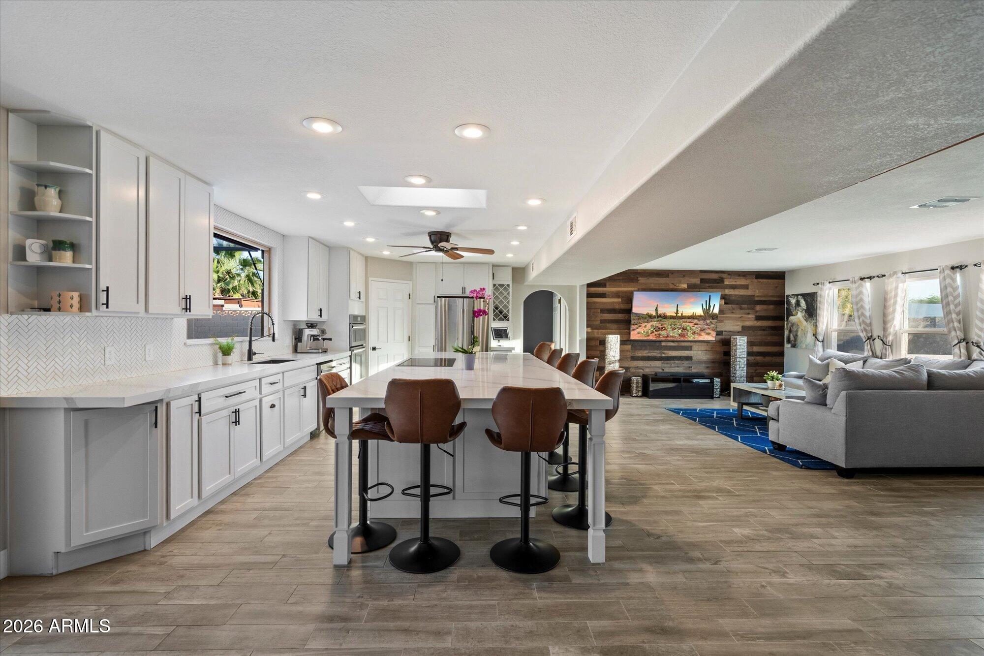 10245 North 34th Place Phoenix, AZ 85028 - Photo 7 of 27 a living room with furniture a dining table and kitchen view