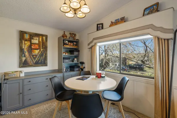 a view of a dining room with furniture window and outside view