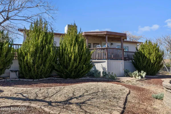 a view of a house with backyard and trees