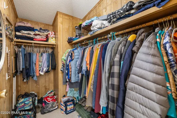 a view of walk in closet with clothes