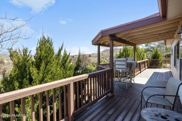 a view of a chair and tables in the balcony