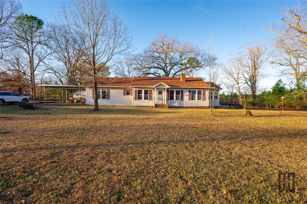 3209 Highway 2 Alternate Haynesville, LA 71038 - Photo 15 of 15 a front view of residential houses with yard and trees