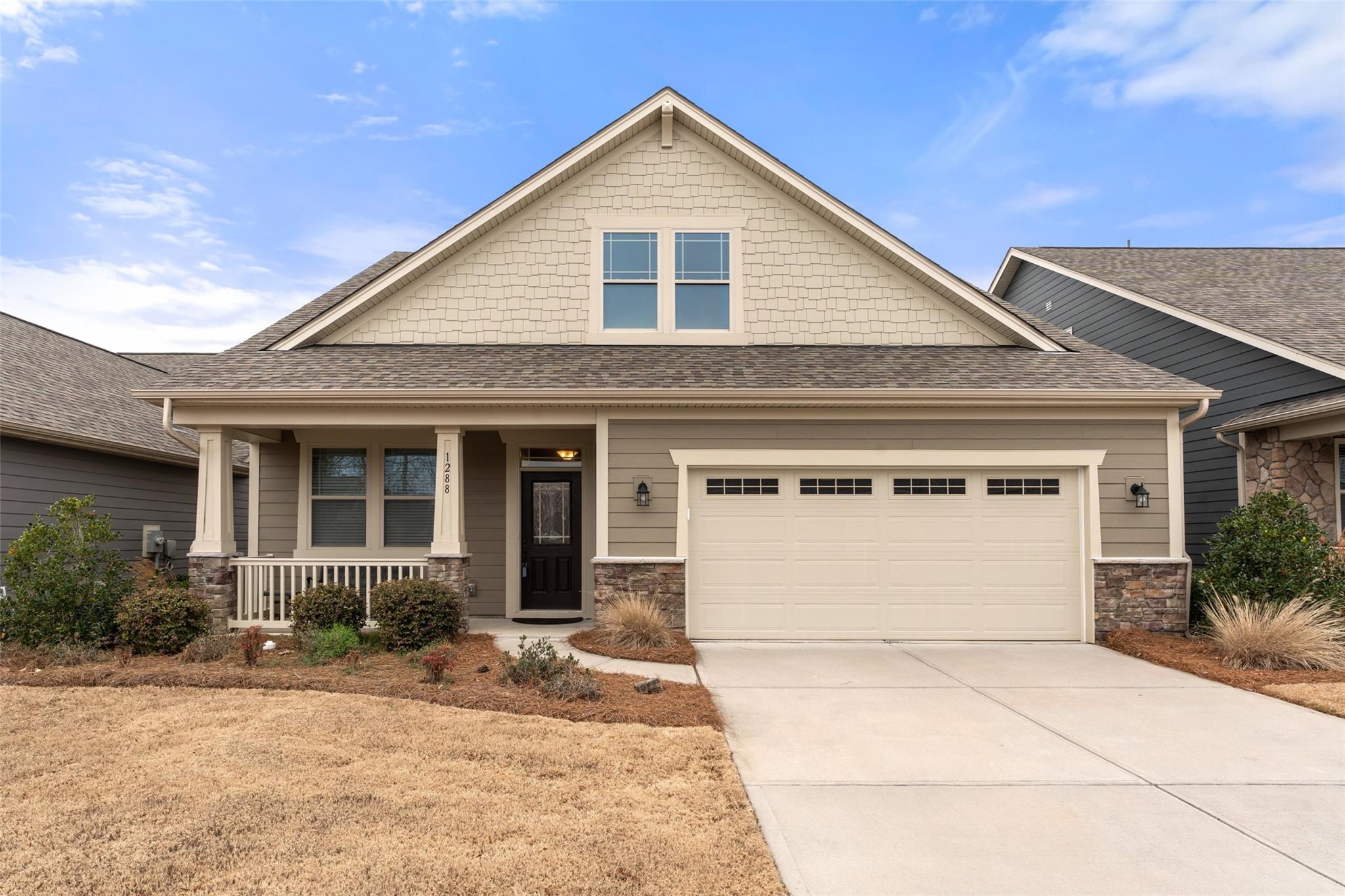 1288 Independence Street Tega Cay, SC 29708 - Photo 3 of 37 a front view of a house with a yard and garage