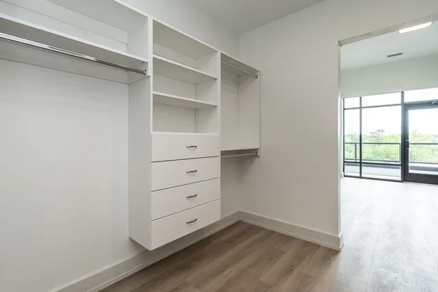 an empty room with closet and wooden floor
