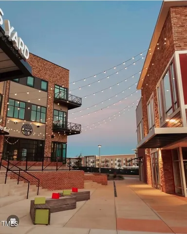 a kitchen with a table chairs and wooden floor