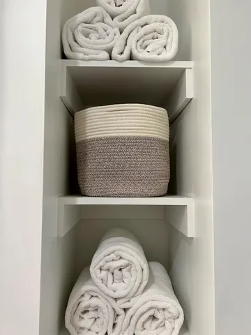 a kitchen with a sink a refrigerator and chairs