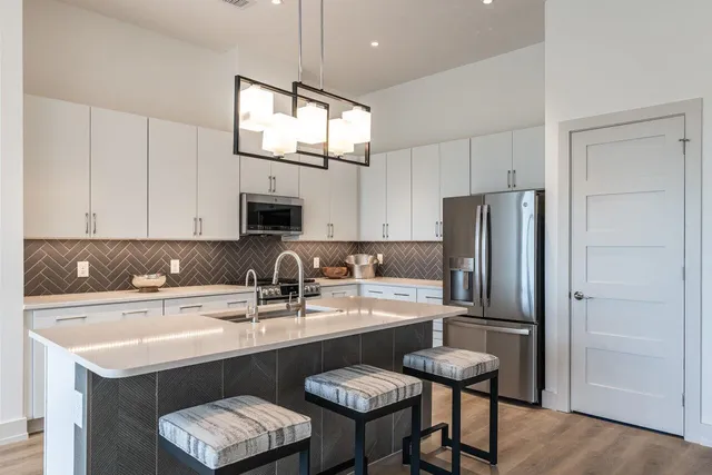 a stove top oven sitting inside of a kitchen
