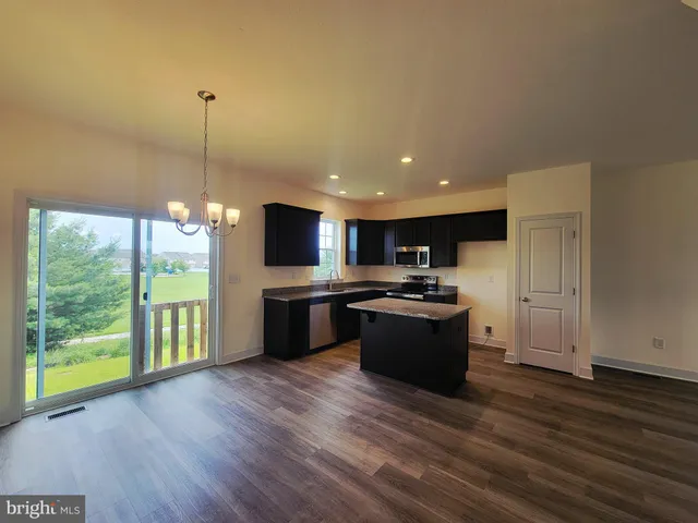 a large kitchen with lots of counter space a sink and appliances