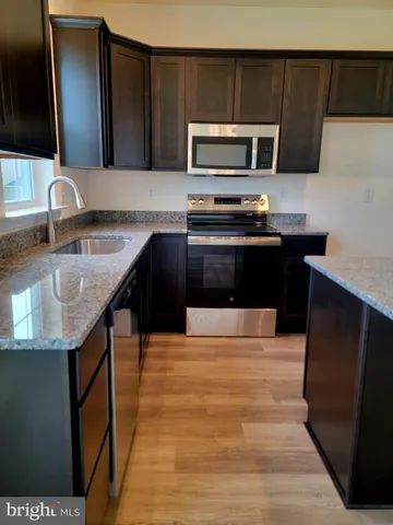 a kitchen with a sink appliances and cabinets
