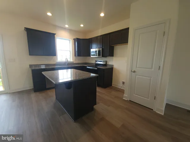 a kitchen with stainless steel appliances granite countertop a stove and a refrigerator
