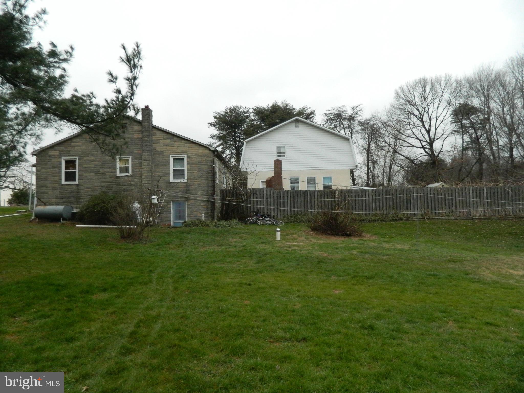 5708 Hilltop Road Baltimore, MD 21220 - Photo 4 of 10 a view of a backyard with plants and large tree