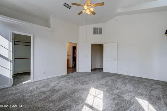 an empty room with windows and entrance