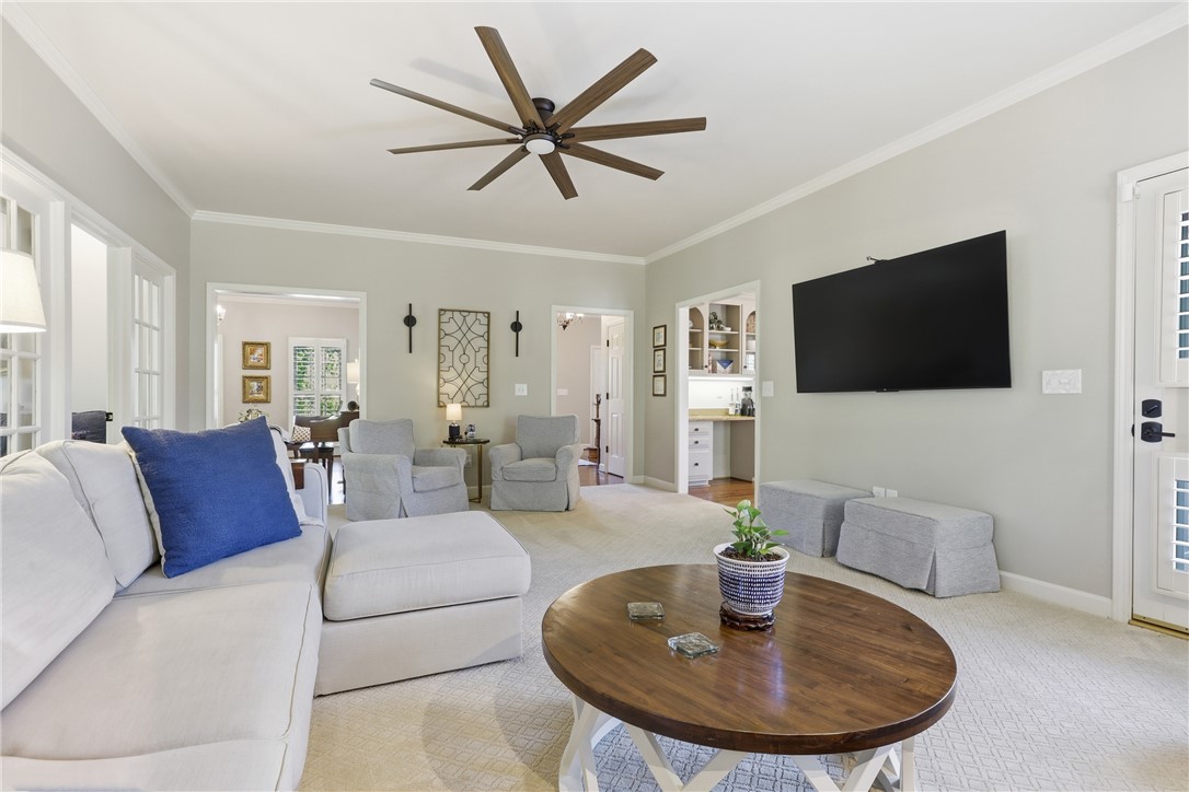 103 5 Knoll Court Anderson, SC 29621 - Photo 5 of 33 A spacious living area with crown molding and warm lighting for inviting gatherings.