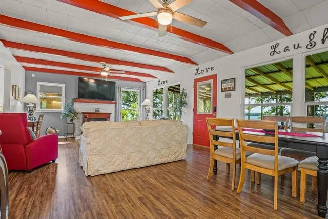 a living room with furniture and a floor to ceiling window