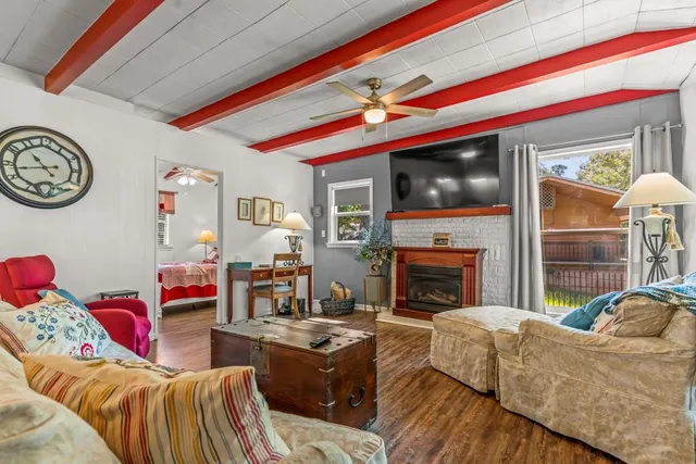 a living room with furniture a flat screen tv and a fireplace