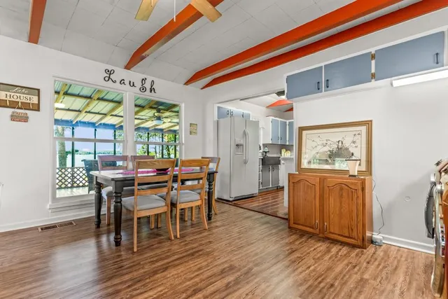 a dining room with furniture and wooden floor