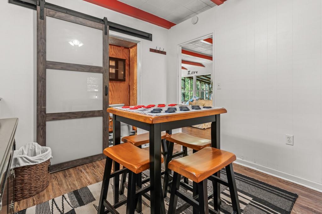 263 Crestwood Loop Avinger, TX 75630 - Photo 17 of 40 a dining room with furniture and wooden floor