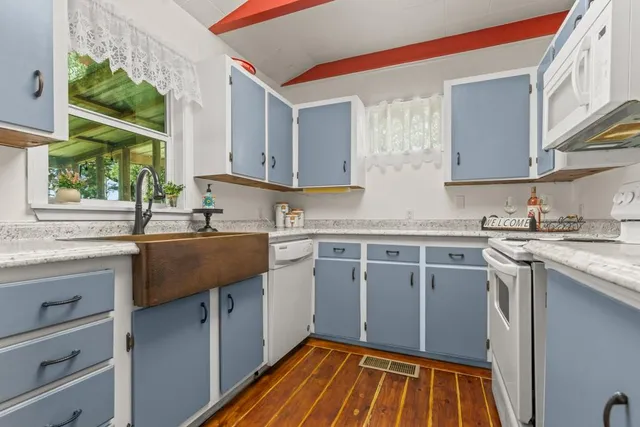 a kitchen with stainless steel appliances granite countertop a sink stove and cabinets