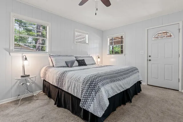 a bedroom with a bed and a window