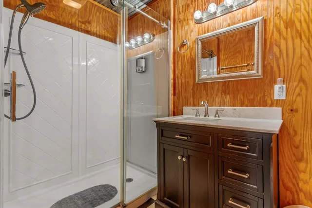a bathroom with a sink a mirror and a shower