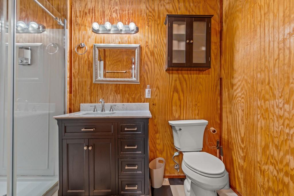 263 Crestwood Loop Avinger, TX 75630 - Photo 24 of 40 a bathroom with a toilet a sink and mirror