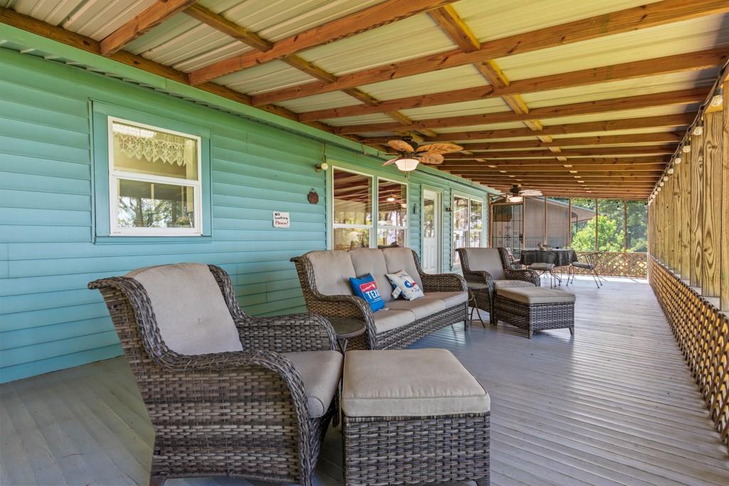 263 Crestwood Loop Avinger, TX 75630 - Photo 28 of 40 a outdoor living space with furniture and a fireplace