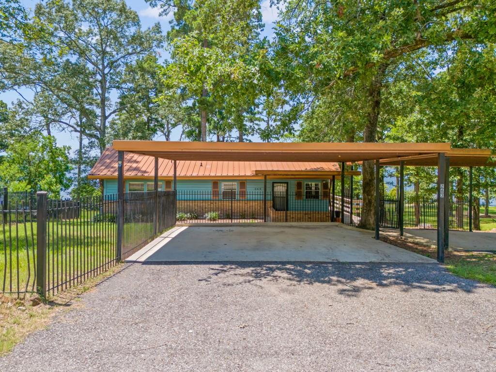 263 Crestwood Loop Avinger, TX 75630 - Photo 30 of 40 a view of backyard with green space and fountain